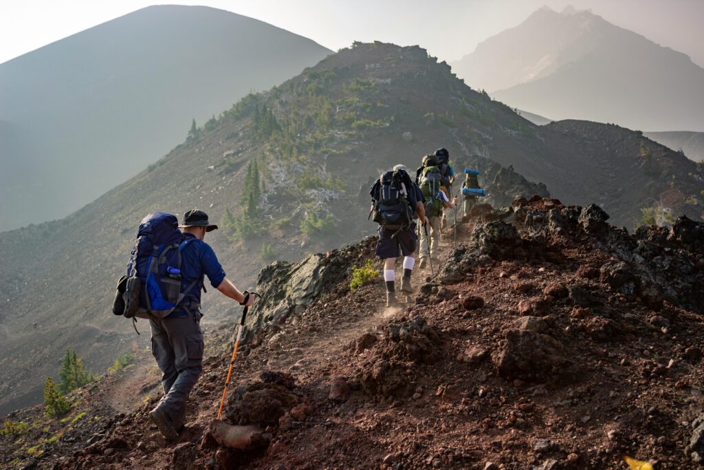 Two people climbing a mountain. Establishing healthy habits for mental health.